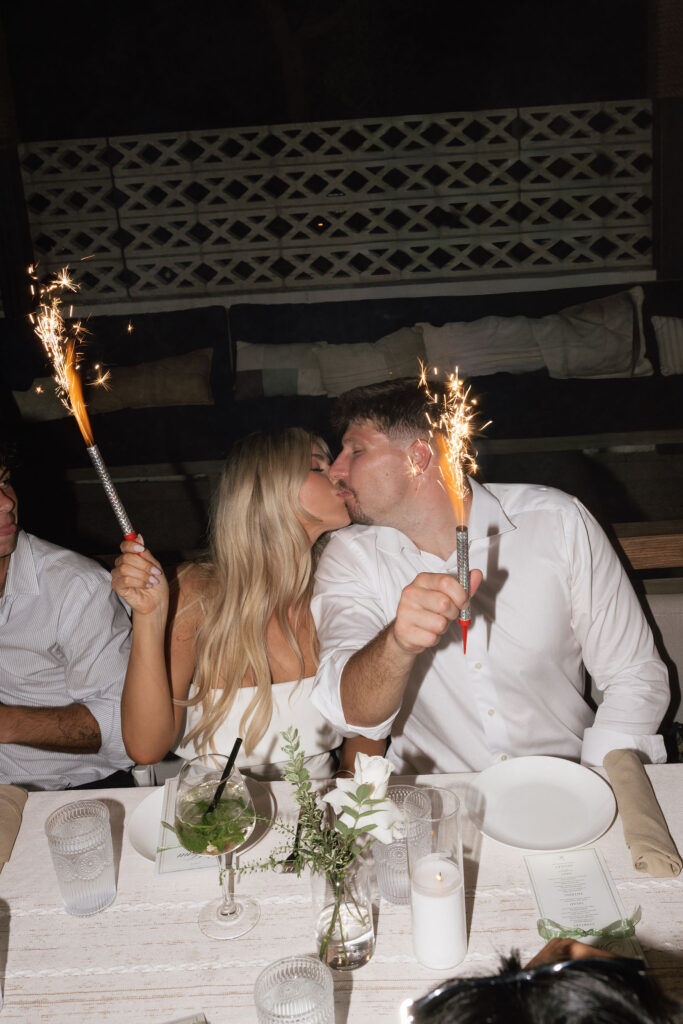 Couple kissing at dinner celebration