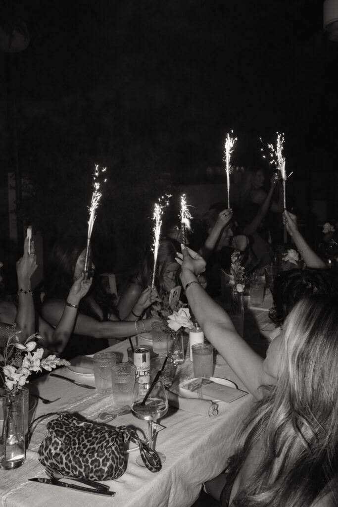 Guests at engagement party with sparklers